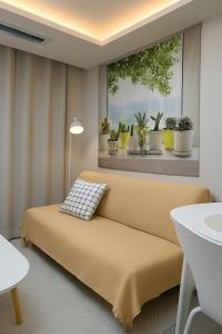 a room with a couch and a window with potted plants at Gate303 in Seoul
