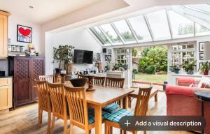 a kitchen and living room with a table and chairs at Double bedroom in homely, 5 bedroom family house by the river in Fulham in London