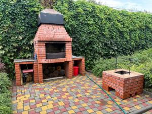 a brick barbecue on a tiled patio in a garden at Дом у моря in Odesa +40 photos