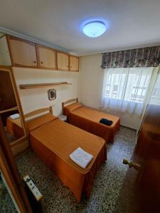 a small room with two beds and a window at APARTAMENTO BEATRIZ 2 in Burriana +11 photos