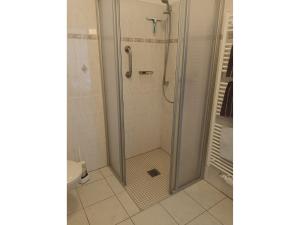 a shower with a glass door in a bathroom at KOS - Haus Netti in Koserow