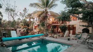 a swimming pool in front of a house at Hacienda De Palmas in La Ribera