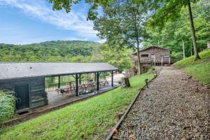 a pavilion with benches and a building in the distance at Ohio Starlight Glamping Cabins - A Peaceful Woodland Retreat 
