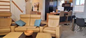 a living room with a couch and chairs and a table at Reethaus "Dat Lavendelhus" in Zierow
