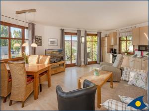 a living room with a table and a kitchen at Villa Ricarda Whg 03 in Ahlbeck