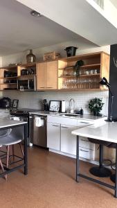 a kitchen with white cabinets and a sink and a table at Center of Hollywood in Los Angeles