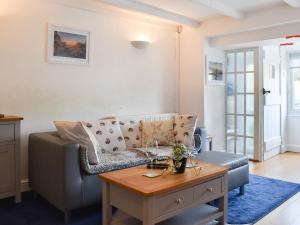 a living room with a couch and a table at Kestrel Cottage in Tavistock