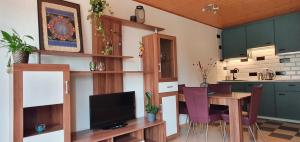 a kitchen with a table and a dining room at Gasthaus Zum Schneider in Pottenstein +27 photos