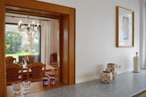a kitchen with a dining room with a dining table at ChiemseeZeit in Gstadt am Chiemsee +27 photos