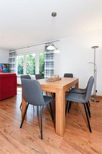 a dining room with a wooden table and chairs at Ferienhaus Möwenweg in Neuharlingersiel