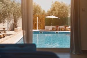 a view of a swimming pool through a window at Eman Resort & Villas in Ulcinj