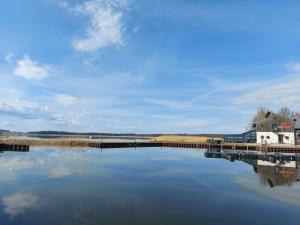 a view of a body of water with a dock at Moderne Ferienwohnung "Parkblick" im Ostseebad Ückeritz in Ueckeritz