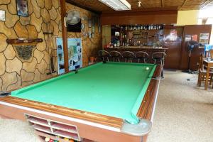 a pool table in a room with a bar at Hope Homes in Panglao Island