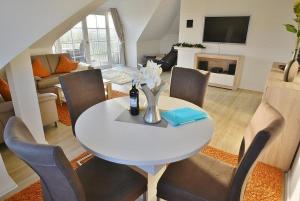 a living room with a white table and chairs at Hafenblick Whg 15 in Grömitz