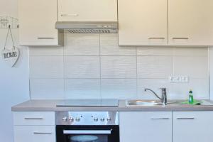 a kitchen with a sink and a stove at Ferienwohnung Lischka in Lübbenau +5 photos