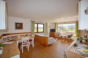 a kitchen and living room with a table and chairs at Bergblick in Bernau am Chiemsee