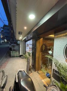 a motorcycle parked in front of a store window at Hotel Oak in Namchi