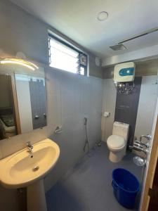 a bathroom with a sink and a toilet at Hotel Oak in Namchi +9 photos