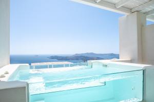 a swimming pool on the roof of a building at Apeiron Blue Santorini - Sustainable Adults Only 14 Plus in Fira