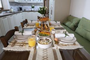 a dining room table with plates and food on it at White Memories boutique home - Romantic Stay in Afandou in Afantou