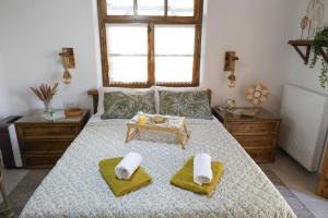 a bedroom with a bed with towels and a table at White Memories boutique home - Romantic Stay in Afandou in Afantou +34 photos