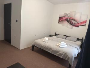 a bedroom with a bed with two towels on it at Apartments Lollipop in Novi Vinodolski