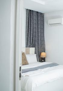 a bedroom with a bed and a window at Suit 360 Abuja in Abuja