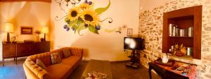 a living room with a couch and a flower on the wall at La Bodega de la Valduerna 2 in Destriana