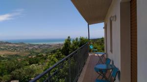 a balcony with a view of the ocean at Casolare Azzurro in Acquaviva Picena