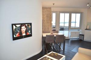 Μια τηλεόραση ή/και κέντρο ψυχαγωγίας στο Residenz Ostseestrand Ferienwohnung Nr 21 Meerblick