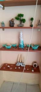 a shelf with a table with a tree on it at Spring studio in Aegina Town +2 photos