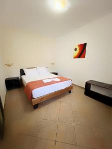 a bedroom with a bed and a painting on the wall at Rainbow Apartments in Skala Potamias +45 photos