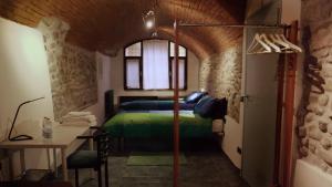 a bedroom with a bed and a table in a room at All' Ombra del Portico in Bologna