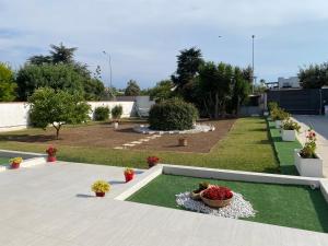 a garden with plants and flowers in a yard at Villa Peonia Luxury in Bisceglie +43 photos