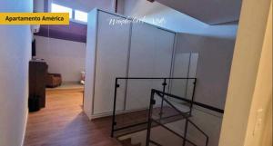 a staircase in a room with a glass wall at WANDERLUST Experience Hotel in Campos do Jordão