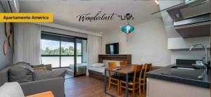 a kitchen and a living room with a couch and a table at WANDERLUST Experience Hotel in Campos do Jordão