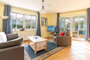 a living room with two chairs and a table at Villa Vogelsang Ferienwohnung 2 "Kranich" in Binz +17 photos