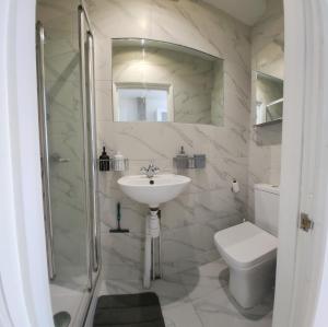 a white bathroom with a sink and a toilet at Oxford Luxury Flat in Oxford +119 photos
