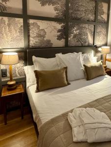 a bedroom with a large bed with white sheets and pillows at Hotel Quinta Solera in Oviedo