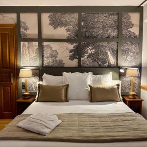 a bedroom with a large white bed with two lamps at Hotel Quinta Solera in Oviedo +46 photos