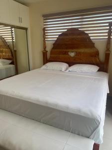 a bed with two pillows on it in a bedroom at Allman luxurious one bedroom near beaches in Llandovery