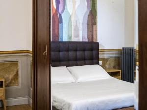 a bed with a black headboard in a bedroom at Palazzo Sapori in Soriano nel Cimino