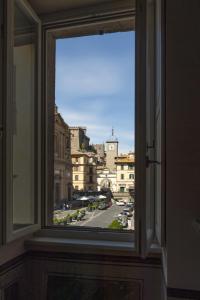 an open window with a view of a city at Palazzo Sapori in Soriano nel Cimino +37 photos