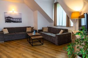 a living room with a couch and a table at Hotel Masuria in Łukta