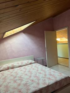 a bedroom with a bed and a wooden ceiling at La Casa dei Pini in Porto San Giorgio