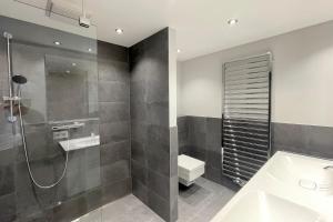 une salle de bains avec douche, toilettes et lavabo dans l'établissement Ferienwohnung Goede Tiid, à Tinnum 21 autres photos