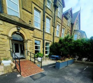 a large brick building with a patio in front of it at Manhattan Lodge in Lytham St Annes