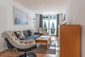 a living room with a couch and a table at Ferienwohnung 11 Villa Eden in Binz +7 photos