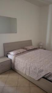 a bedroom with a bed and a mirror on the wall at Apartment Gaia in Nardò +16 photos