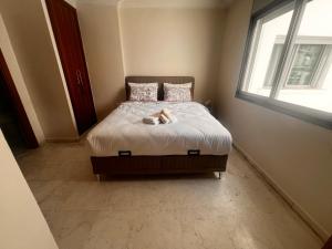 a bedroom with a bed with a cat laying on it at Family apartment NZ in Tangier +33 photos